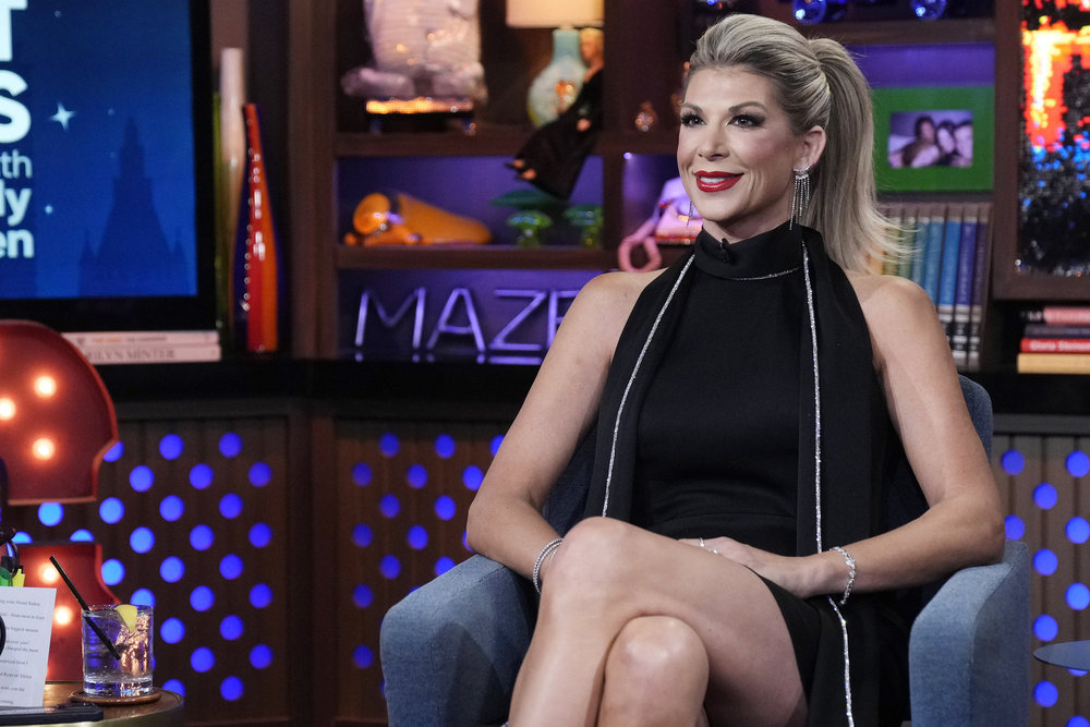 Alexis Bellino looks stunning in a black dress with red lips on WWHL.